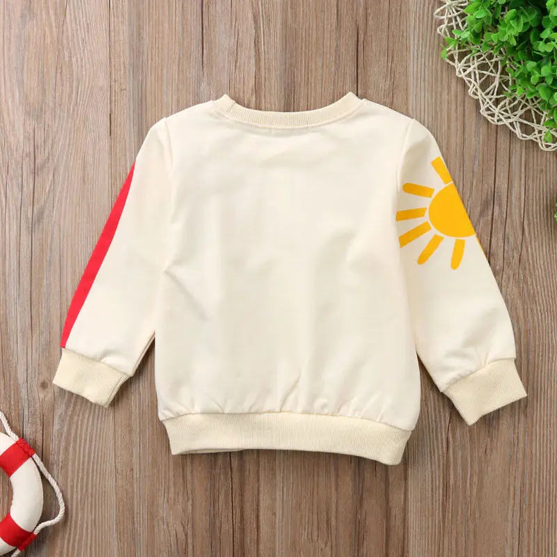 Sweat coloré bébé fille – Arc-en-ciel, chaleur et bonne humeur.
